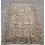 A CREAM GROUND KESHAN RUG with allover floral design and multiple borders, 350cm x 240cm Condition
