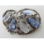 A BROOCH IN THE STYLE OF BERNARD INSTONE with freeform moonstone cabouchons and blue topaz set to