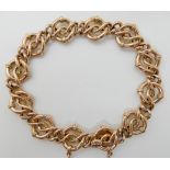 A 9CT ROSE GOLD KNOT PATTERN LINK BRACELET with box clasp and safety chain, approx dimensions of the