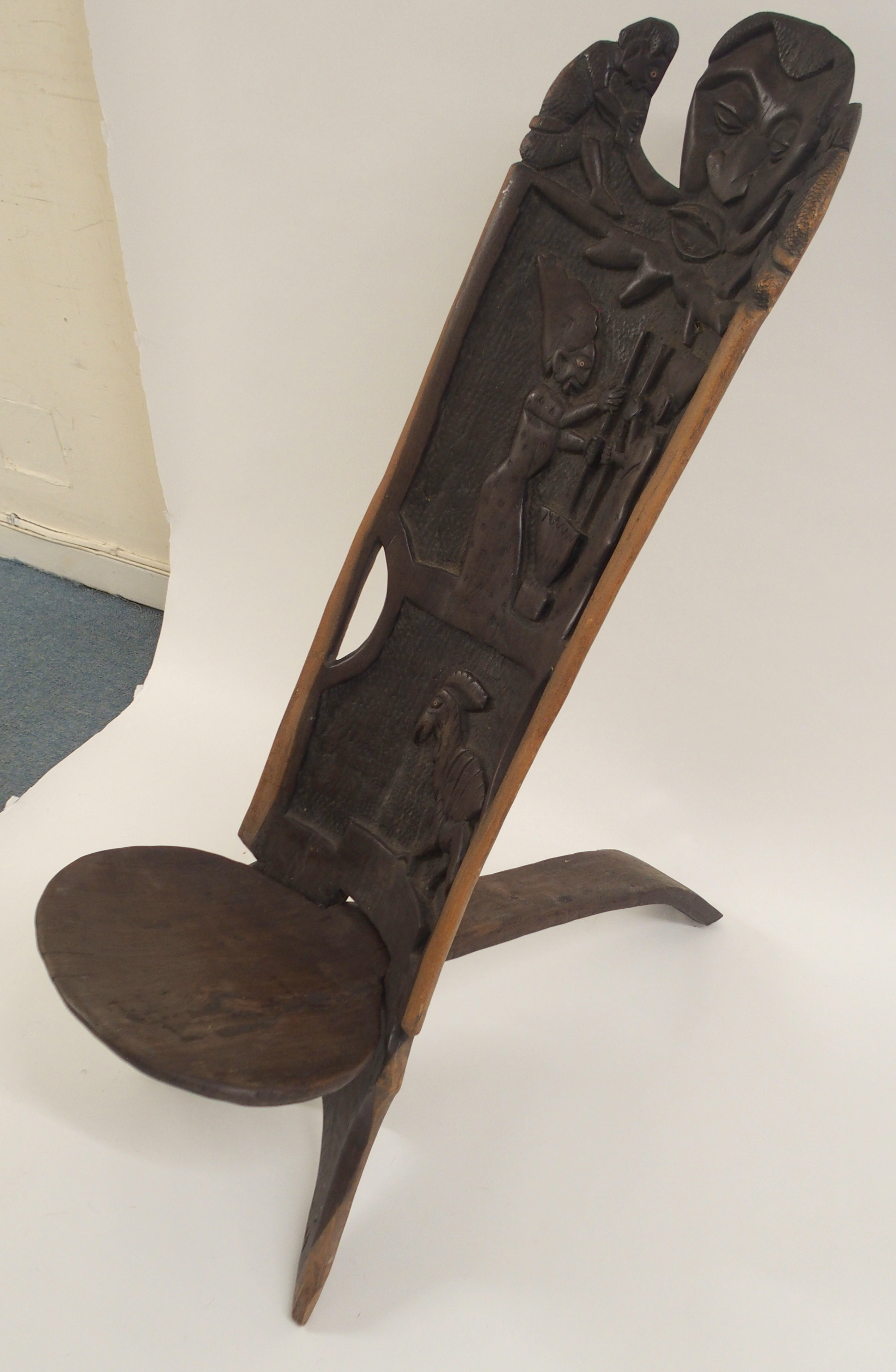 AN AFRICAN CARVED BIRTHING CHAIR the back with face mask flanked by two figures, above two women - Image 7 of 11