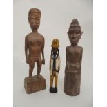 AN AFRICAN COLONIAL CARVED WOOD DOCTOR FIGURE standing and painted in bright colours, 30cm high
