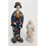 AN ARITA MODEL OF A BIJIN standing and wearing blue kimono decorated with Ho-o birds and foliage,