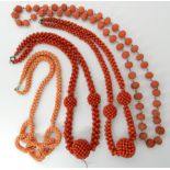 A COLLECTION OF CORAL BEADS a carved string of coral beads, with carved coral clasp, strung