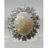 AN 18CT WHITE GOLD OPAL AND DIAMOND CLUSTER RING the white opal is approx 10.7mm x 8.6mm and further
