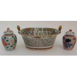 A CANTONESE TWO HANDLED BASKET painted with panels of birds, flowers, fruit an foliage, with multi-