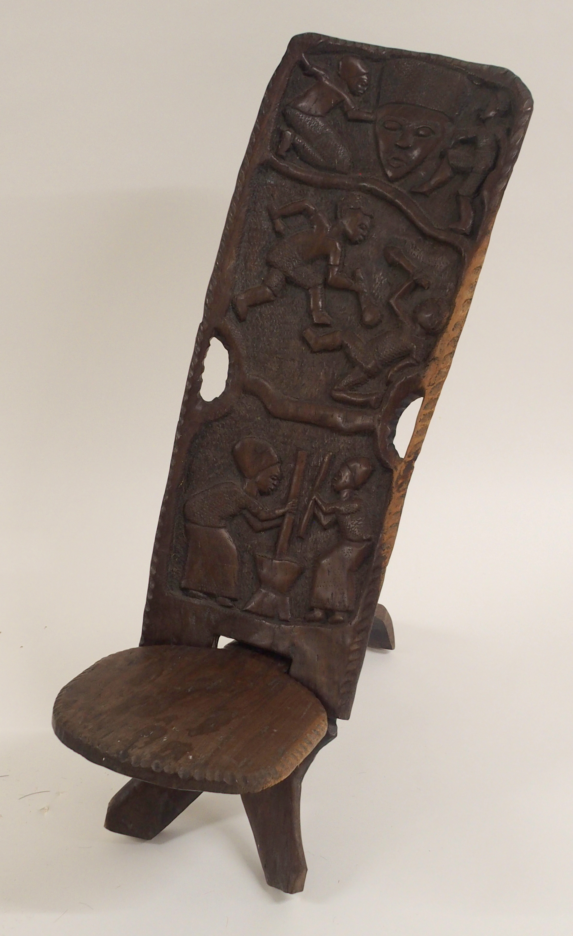 AN AFRICAN CARVED BIRTHING CHAIR the back with face mask flanked by two figures, above two women - Image 2 of 11