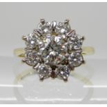 AN 18CT GOLD DIAMOND FLOWER RING set with estimated approx 1ct of brilliant cut diamonds, finger