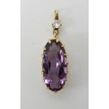 AN AMETHYST AND DIAMOND PENDANT the oval amethyst measures approx 17mm x 8.1mm x 5.4mm in a multi-