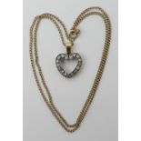 A DIAMOND SET HEART PENDANT made in yellow and white metal and set with estimated approx 0.34cts