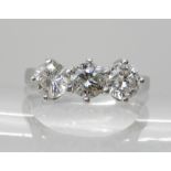 A PLATINUM THREE STONE DIAMOND RING set with estimated approx 1ct of brilliant cut diamonds.