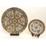 A LARGE CANTON FAMILLE ROSE DISH painted with panels of birds, butterflies, flowers and fruit,