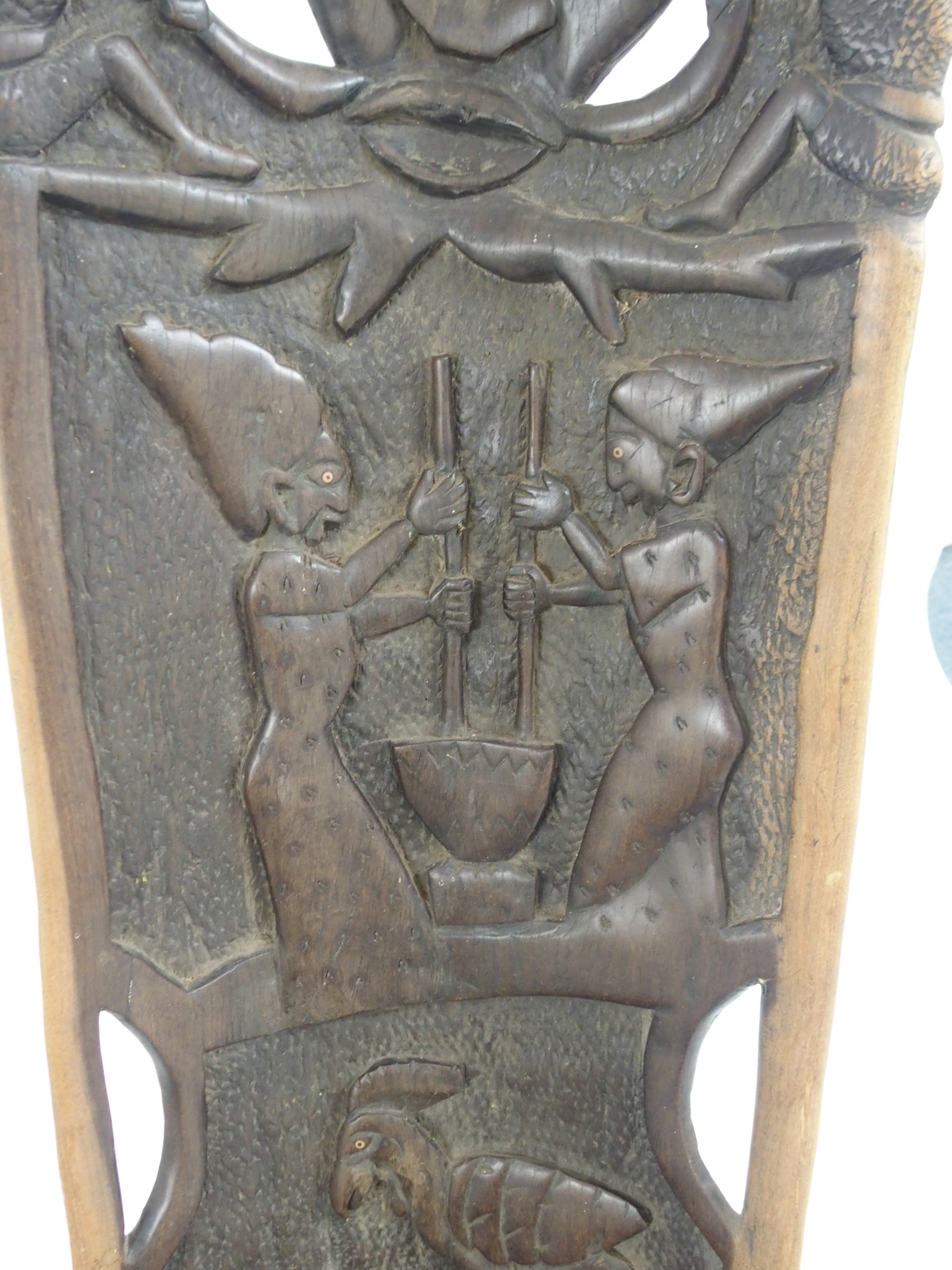 AN AFRICAN CARVED BIRTHING CHAIR the back with face mask flanked by two figures, above two women - Image 5 of 11