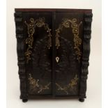 AN ANGLO INDIAN EBONY TABLE CABINET the hinged doors inlaid with scrolling foliage and applied