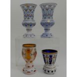 A PAIR OF BOHEMIAN WHITE OVERLAID BLUE GLASS VASES with cut detail and painted flower decoration,