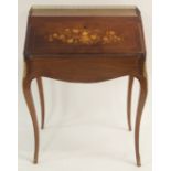 A ROSEWOOD BONHEUR DU JOUR with three quarter brass gallery above a foliate inlaid hinged shaped top