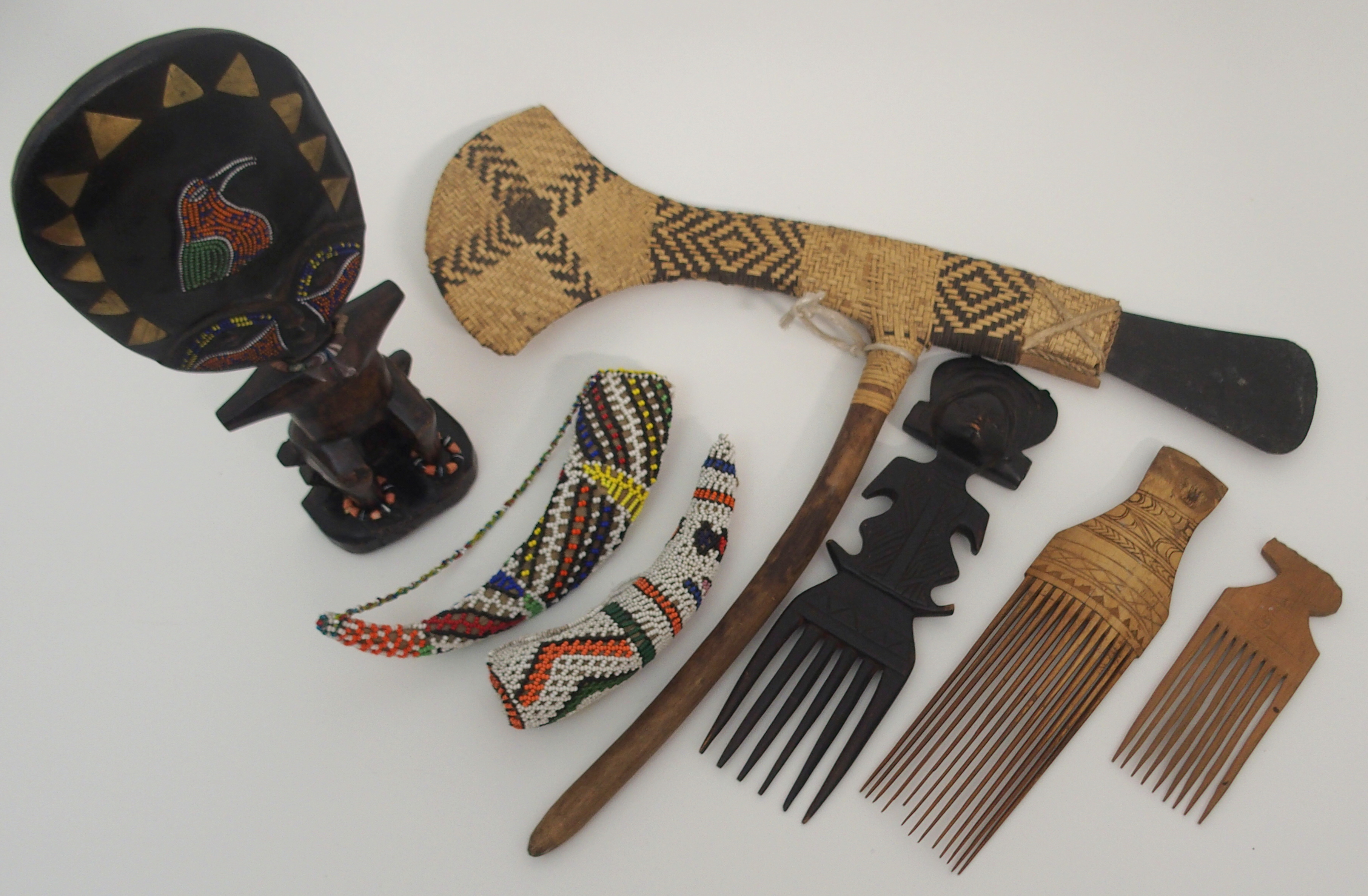 A GROUP OF AFRICAN TRIBAL ITEMS comprising; a Papua New Guinea ceremonial slate and wicker axe, 57cm