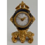 A FRENCH TIMEPIECE the circular blue glazed body with ormolu mounts and painted in gilt with flowers