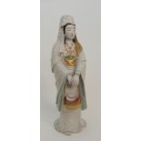 AN ARITA MODEL OF KANNON standing in long flowing robes painted in opaque, black, ochre and gilt and