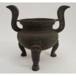 A LARGE CHINESE BRONZE INCENSE BURNER with high scroll handles joined to a bulbous body and on three