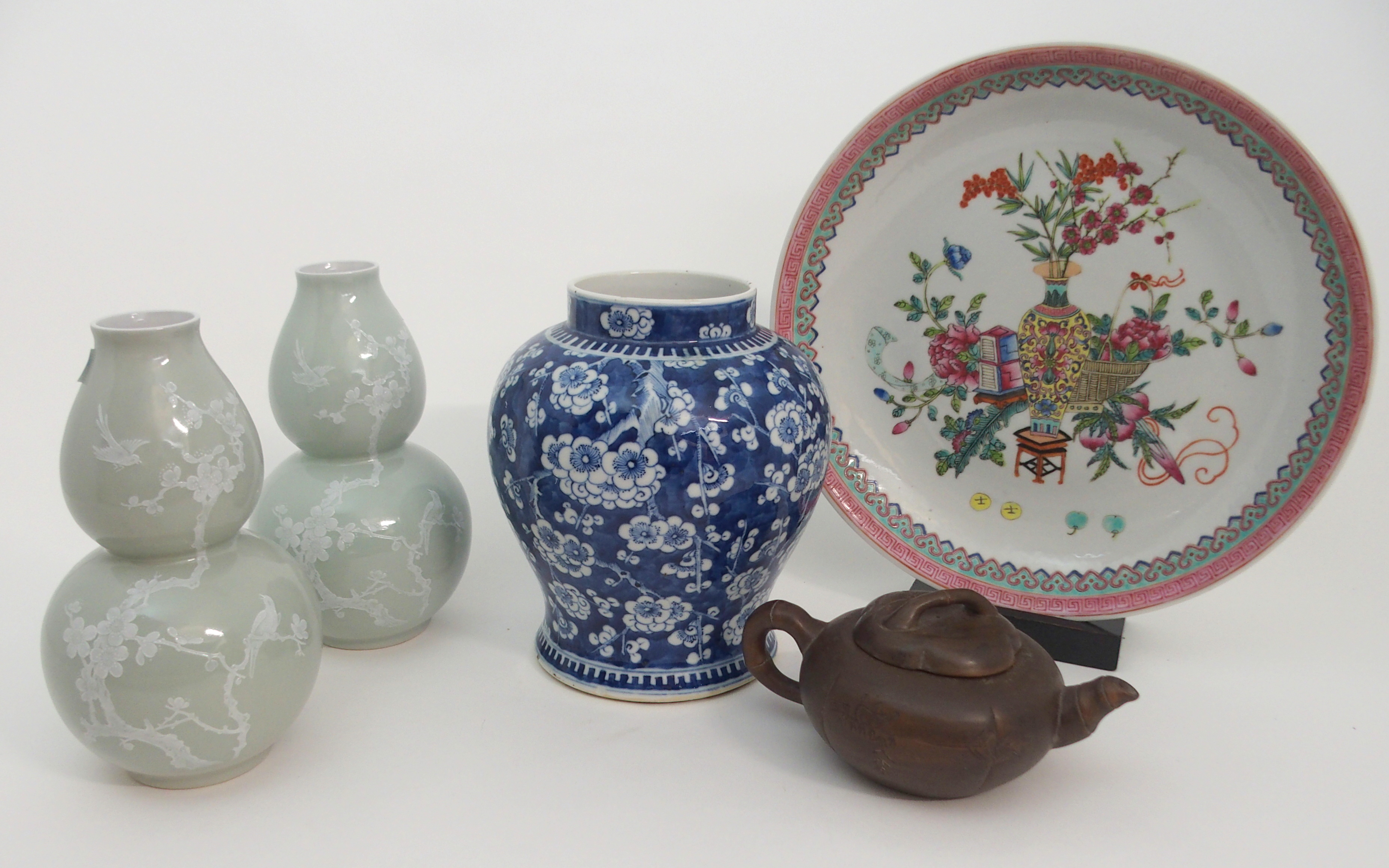 A CHINESE FAMILLE ROSE DISH painted with precious objects within a key and ruji head border, 32.