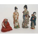 AN ARITA FIGURE OF KANNON standing and holding a scroll, 25cm high, Bijin with cat at her feet, 27cm