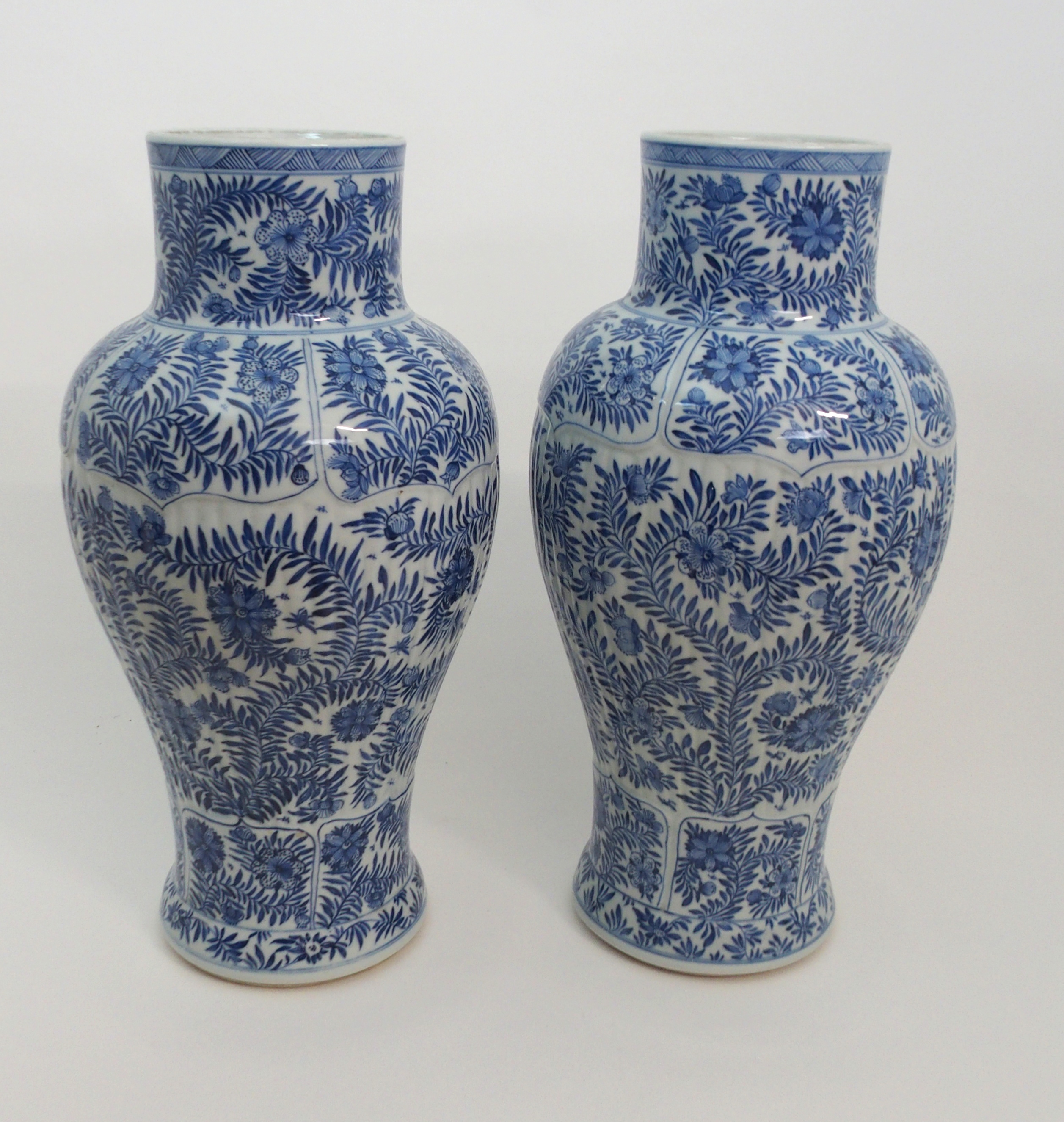 A PAIR OF CHINESE BLUE AND WHITE MOULDED BALUSTER VASES AND A COVER painted with panels of flowers - Image 3 of 12