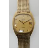 A 9CT GOLD OMEGA AUTOMATIC DE VILLE WRISTWATCH with gold coloured dial and baton numerals with