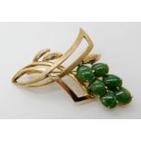 A 14K GOLD CHINESE GREEN HARDSTONE BROOCH RETAILED BY LIBERTYS the foliate design is set with six