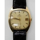 A GENTS 9CT GOLD OMEGA AUTOMATIC DE VILLE with a cream coloured dial with gold coloured baton