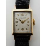 A LADIES 14K GOLD TIFFANY & CO WRISTWATCH with oblong case approx 2.5cm x 1.4cm, white dial with