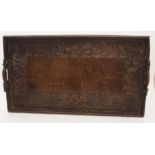 A CHINESE HARDWOOD CARVED TEA TRAY decorated with dragons, geometric knot patterns and Shou