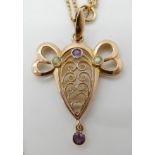 A 9CT GOLD PERIDOT AND AMETHYST ART DECO PENDANT of scrolling design, length of pendant with bail