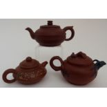 THREE YIXING TEAPOTS a compressed globular teapot, 16.5cm wide, painted teapot, 13cm wide and a