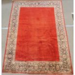 A RED GROUND SAROUGH RUG with floral border, 312cm x 222cm Condition Report: Available upon request
