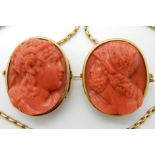 A PAIR OF CARVED CORAL CAMEOS OF CLASSICAL THEME joined together with a yellow metal chain, all