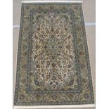 A LIGHT GROUND FINE LAMBS WOOL KESHAN with blue central medallion and borders, 218cm x 140cm