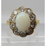 AN 18CT GOLD OPAL AND DIAMOND CLUSTER RING the white opal is approx 9.1mm x 6.8mm x 2.6mm, further