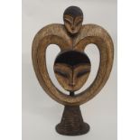 A GROUP OF AFRICAN CARVED OBJECTS comprising; a Gabon twin head carving on wicker stand, 59cm