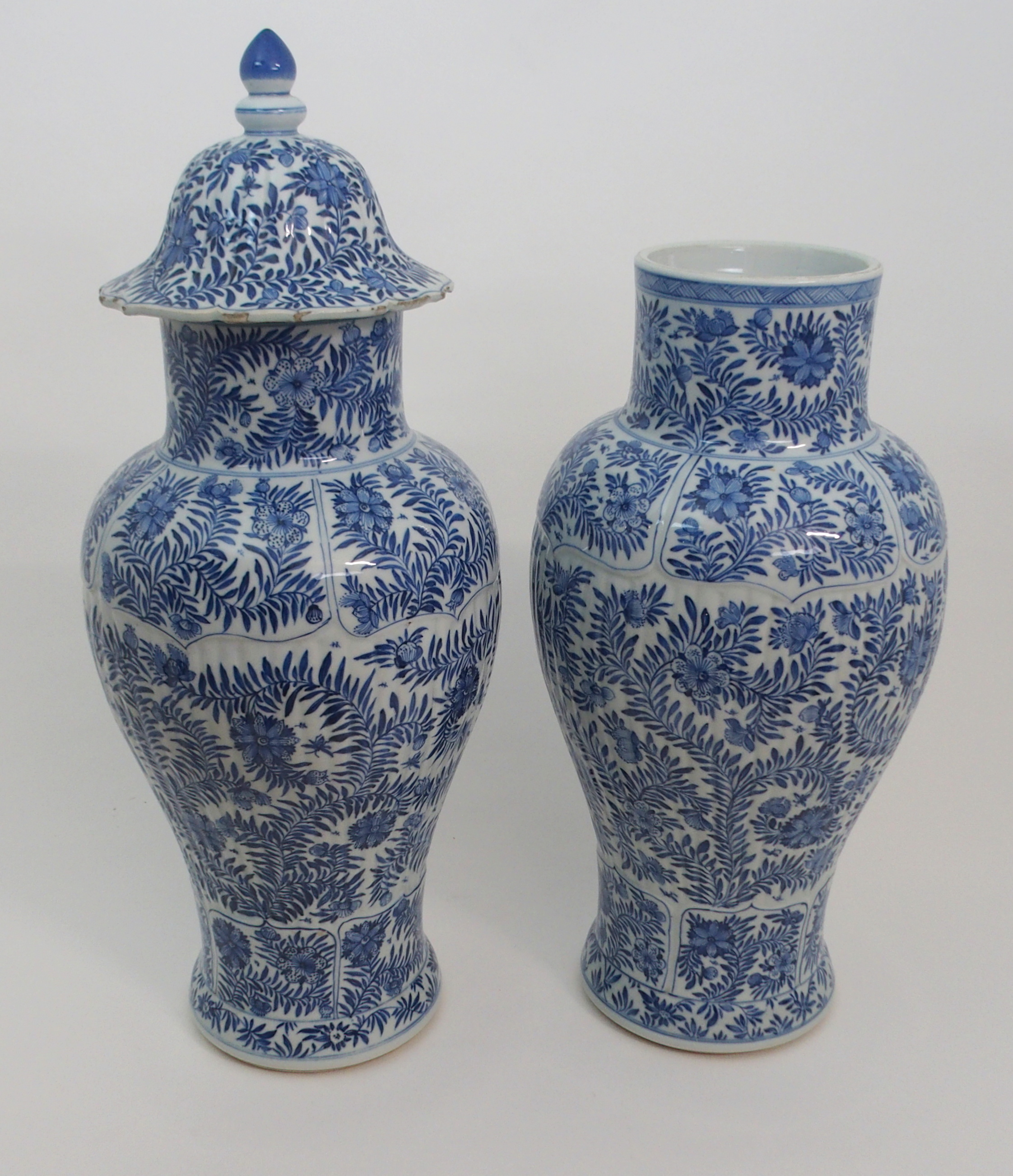 A PAIR OF CHINESE BLUE AND WHITE MOULDED BALUSTER VASES AND A COVER painted with panels of flowers - Image 2 of 12