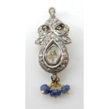 AN INDIAN STYLE DIAMOND AND SAPPHIRE PENDANT the eight cut diamonds set in yellow and white metal