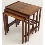 A MID-CENTURY ROSEWOOD NEST OF THREE TABLES 50cm high x 49cm wide x 37cm deep Condition Report:
