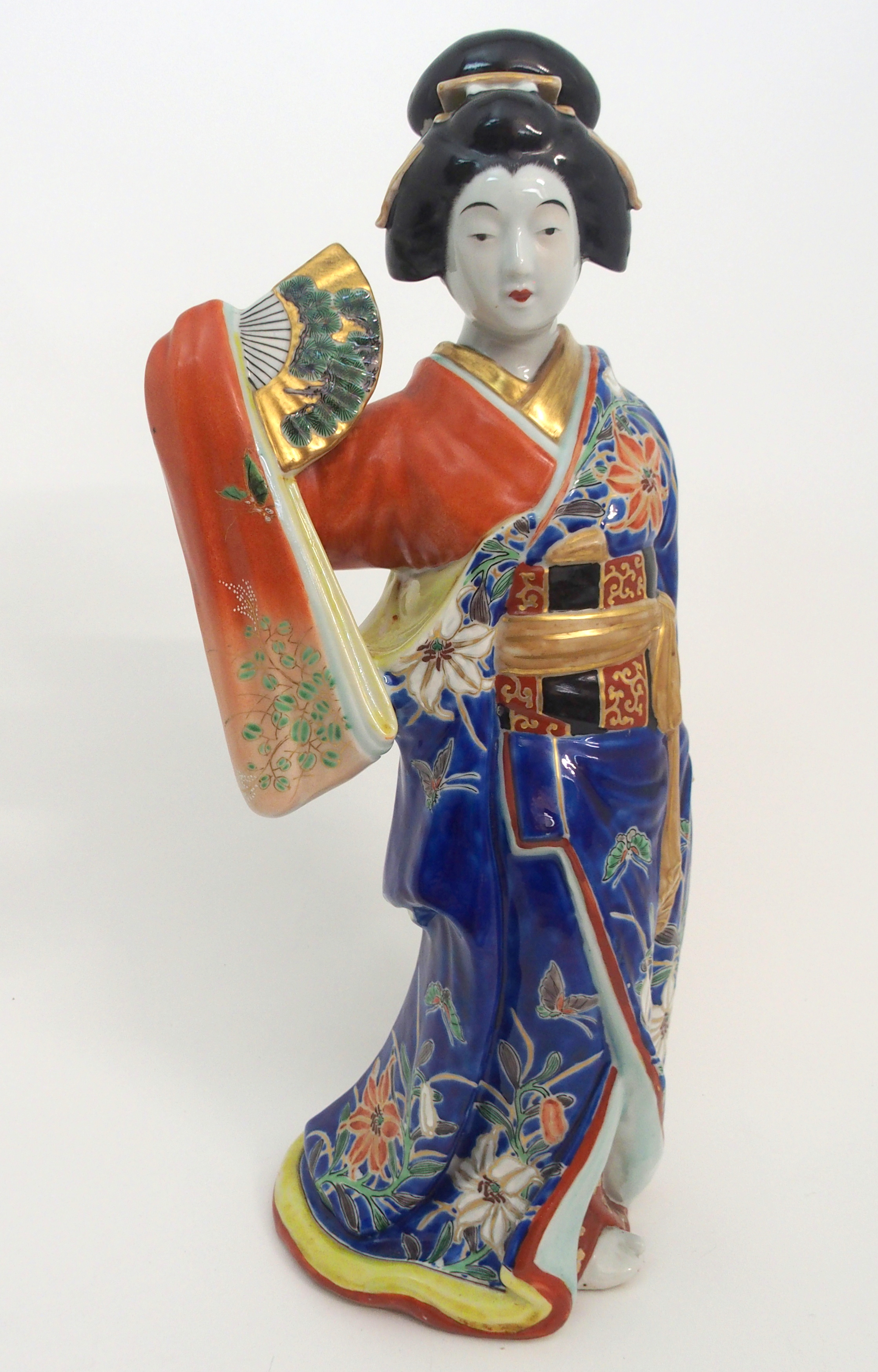 AN ARITA BIJIN FIGURE modelled holding a fan and wearing elaborate kimono, 45cm high Condition