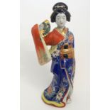 AN ARITA BIJIN FIGURE modelled holding a fan and wearing elaborate kimono, 45cm high Condition