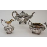A LATE WILLIAM IV SILVER THREE PIECE TEA SERVICE by John Wellby, London 1837, the lobed body with