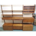 A POUL CADOVIOUS (1911 - 2011) TEAK MODULAR SHELVING SYSTEM the three uprights support open shelves,