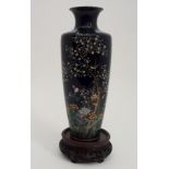 A JAPANESE CLOISONNE BALUSTER VASE decorated with a bird perched amongst blossoming branches and