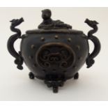 A CHINESE BRONZE CENSER AND COVER the cover cast with a figure, flanked by serpent handles and above