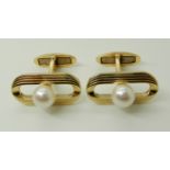 A PAIR OF YELLOW METAL PEARL SET CUFFLINKS stamped K14, the retro oval faces set with a pearl of