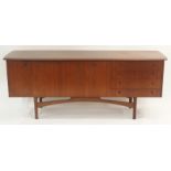 A DALESCRAFT AFROMOSIA TEAK SIDEBOARD designed by Malcolm David Walker, the overhanging shaped top