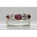 AN 18CT GOLD RUBY AND DIAMOND RING central ruby approx diameter 4mm, the combined estimated approx